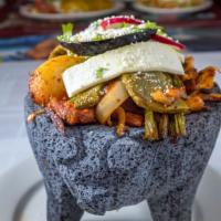 Molcajete · Grilled Steak, Chicken, Spicy Pork, cactus, onion, scallions, fresh Mexican cheese, radishes...