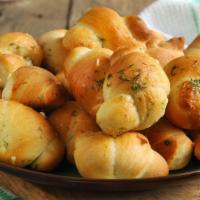 Garlic Knots · Freshly baked garlic knots served with a savory marinara dipping sauce.