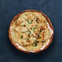 Garlic Naan · Indian flatbread baked to perfection in a traditional Indian clay oven and sprinkled with mi...