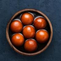 Gulab Jamun  · Soft berry sized balls soaked in rose flavored sugar syrup.