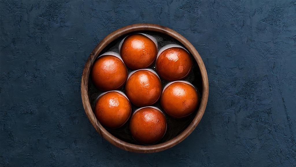 Gulab Jamun  · Soft berry sized balls soaked in rose flavored sugar syrup.