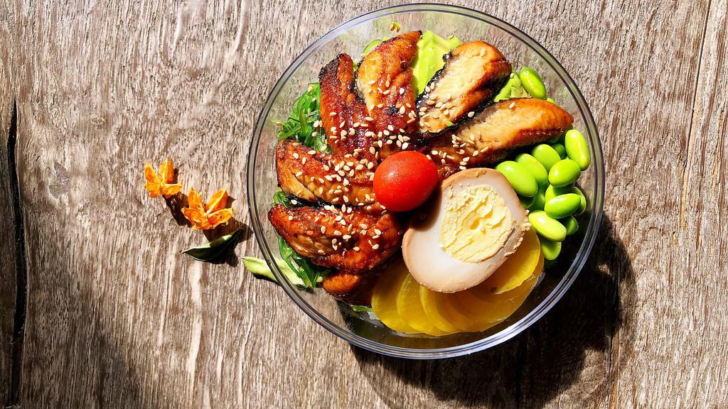 Unagi Don · Eel, avocado, edamame, seaweed salad, oshingo, sesame, tea-egg, and eel sauce.