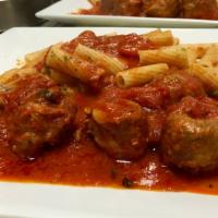 Braciole Over Rigatoni · Pork braciole slow cooked in a pomodoro sauce served over rigatoni