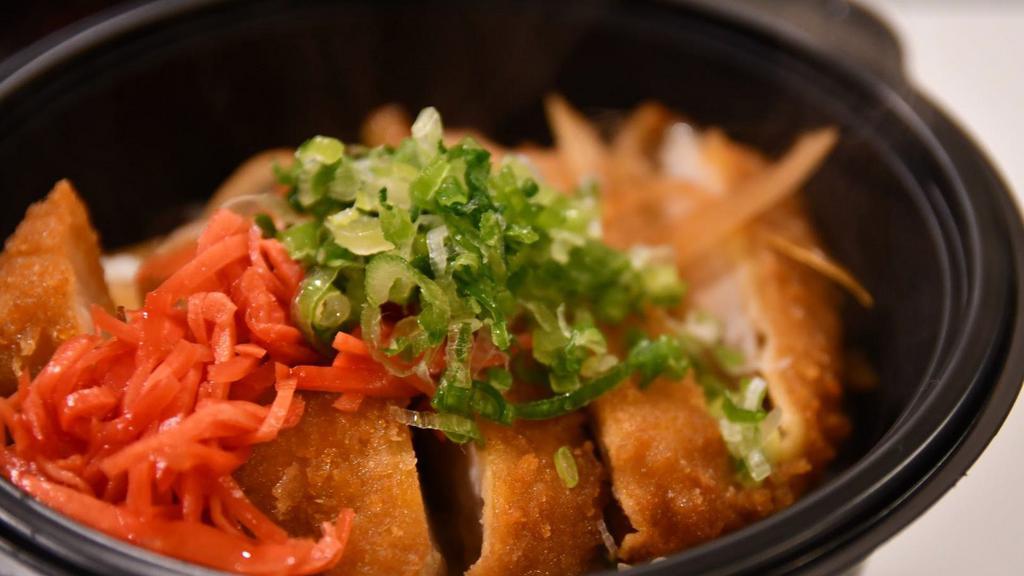 Pork Katsu Don · Pork cutlet cooked with egg and sliced onion in special japanese sauce. Topped with scallion and pickled red ginger, served with rice.