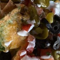Nacho Supreme · Veggie. Layered nachos with refried beans,, pico de gallo, jalapeño, black and green olives ...