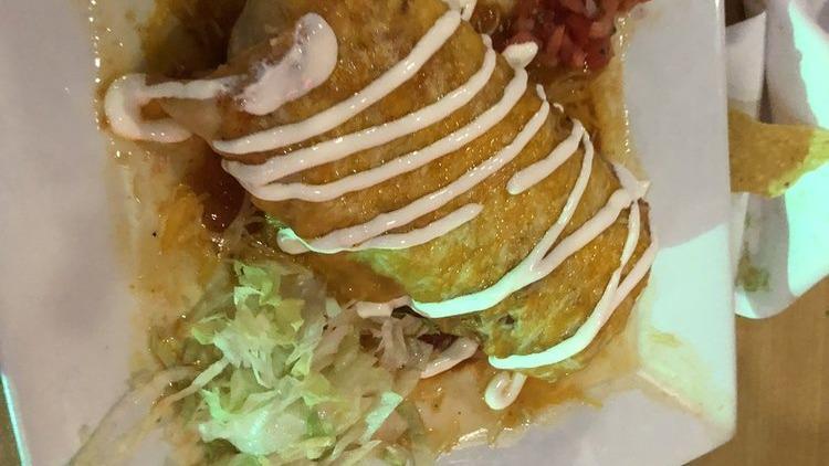 Chimichangas · Deep fried flour tortilla stuffed with rice, beans, sour cream, quacamole and your choice of chicken or steak topped with smoke tomato sauce and melted cheese.