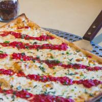 Grandma Pizza · Thin square pizza with fresh mozzarella, fresh basil leaves and crushed tomatoes.
