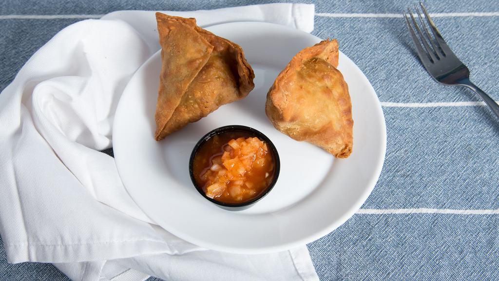Samosa (2 Pieces) · Fried pastry with a savory filling, spiced potatoes and peas.