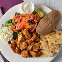Chicken Souvlaki · Served with Greek salad and french fries.