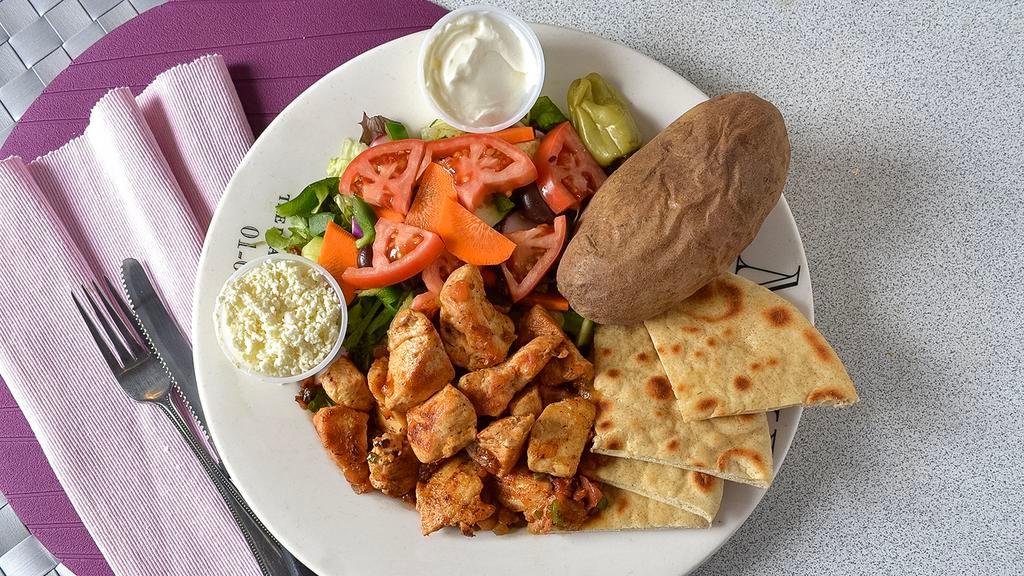 Chicken Souvlaki · Served with Greek salad and french fries.