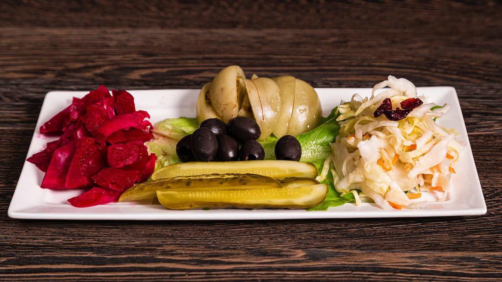Pickled Veggies · Ensemble of homemade pickled coleslaw, red cabbage, pickles, green tomatoes and olives.