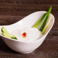 Suzma · Thick lightly salted yogurt with cucumber sticks.