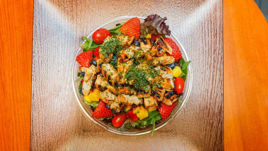 Grilled Chicken Salad · With mixed greens, peppers, mangos, strawberries,  blueberries, cucumbers, cherry tomatoes, topped with our savory grilled chicken.