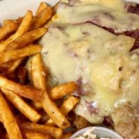 Classic Reuben · Corned beef with Swiss cheese sauerkraut & Russian dressing on grilled rye served with Frenc...