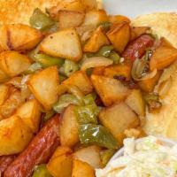 Italian Hot Dog · Two hot dogs on an Italian roll with peppers, onions and cubed potatoes.