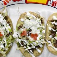 3 Pcs Tlayoyos · Tortilla stuffed with beans and topped with lettuce, cheese, and cream. / Rellenos de frijol...