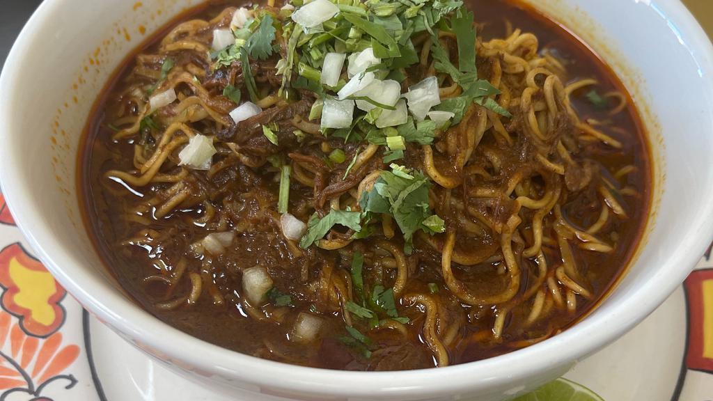 Birria Ramen  · Pasta noodles with birria broth and cilantro and onions on the side.