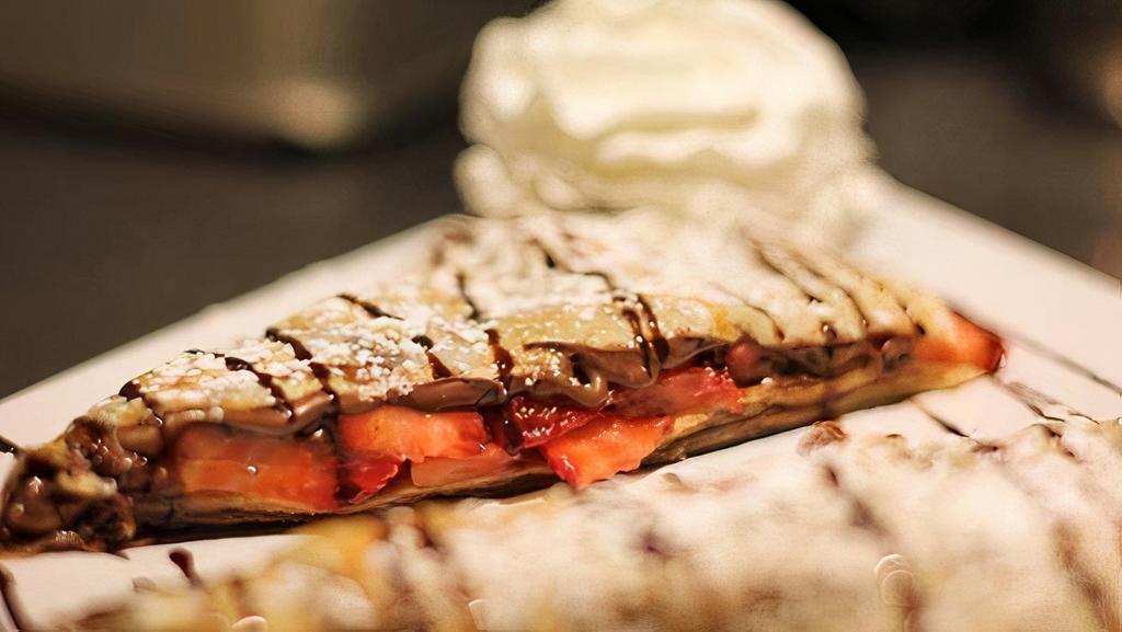 Chocolate Cover Crepe · Melted nutella and fresh sliced strawberries.
