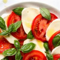 Caprese Salad · Imported fresh mozzarella, darterino tomatoes, basil, and EVOO.