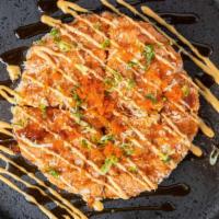 Japanese Pizza · Tortilla pancake top with avocado, sliced tuna, masago and scallion, spicy mayo sauce and ee...