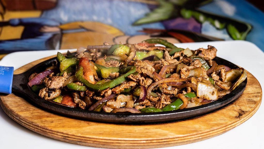 Fajitas · Tender sliced grilled chicken or beef with tomatoes, onion and bell peppers served with rice, beans, lettuce, guacamole, sour cream and two tortillas.