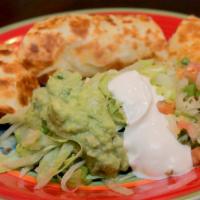 Quesadilla Rellena · A grilled flour tortilla with a choice of chicken or ground beef, melted cheese served with ...