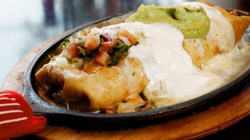 Chimichangas · Two flour tortillas, soft or fried, filled with ground beef or chicken or pork, beans, lettuce, tomatoes, sour cream, nacho cheese sauce and guacamole.