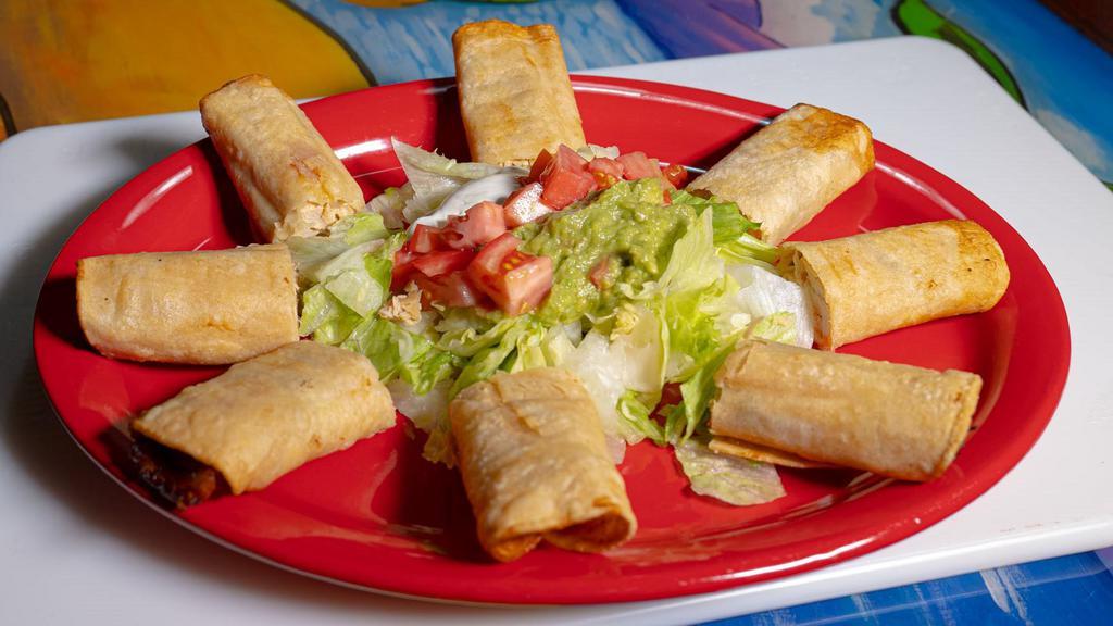 Taquitos Mexicanos · Four fried corn taquitos with chicken, lettuce, guacamole, tomatoes and sour cream.