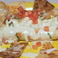 Chicken Flautas · Three fried corn chicken taquitos topped with cheese sauce and served with rice and sour cre...