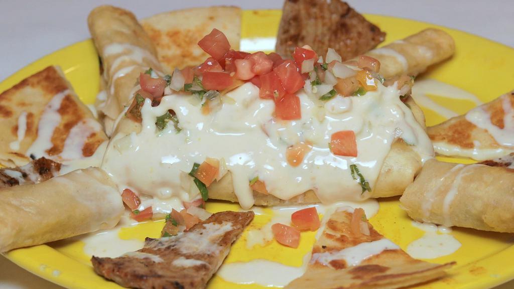 Chicken Flautas · Three fried corn chicken taquitos topped with cheese sauce and served with rice and sour cream.