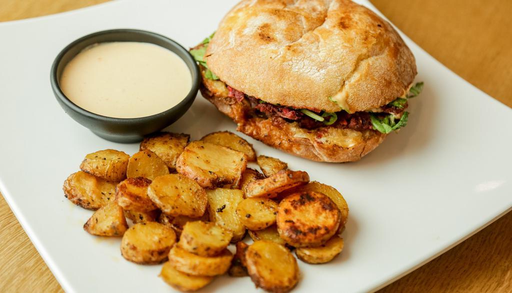 Seattle Burger · Beet-pea patty with oats, grilled shallots, mushrooms, arugula, and espresso aioli on pressed ciabatta or gluten-free bread with a side of grilled fingerlings.