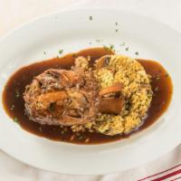 Braised Osso Buco Pork Shank · Over mushroom Risotto Milanese sauce.