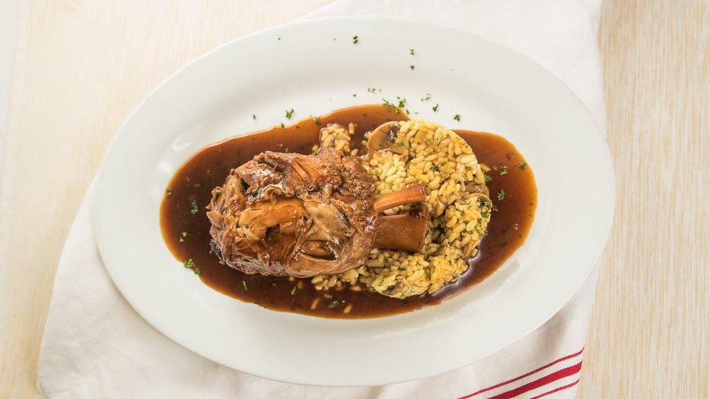 Braised Osso Buco Pork Shank · Over mushroom Risotto Milanese sauce.
