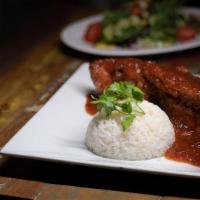 Pescado En Chile Y Tamarindo · Whole red snapper, garlic, tamarind and chili sauce, mixed salad and white rice.