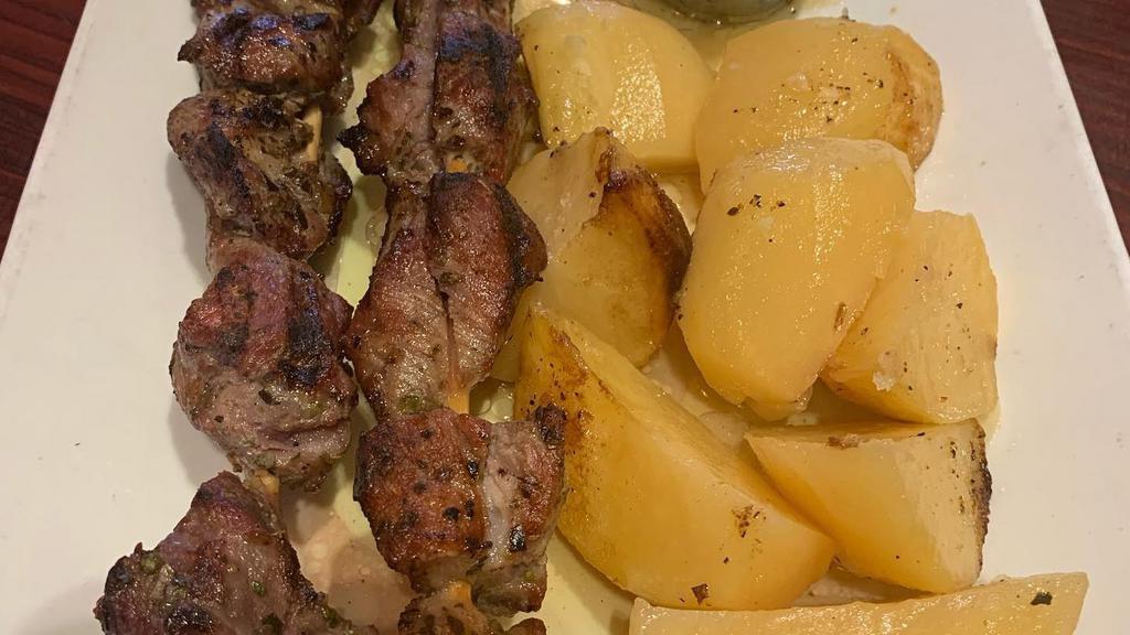 Pork Souvlaki Platter · Two sticks. served with tzatziki sauce greek salad and your choice of add-on.
