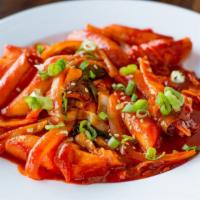 Ttuckppokki (Tuck-Po-Key) · Chewy Korean rice cakes and vegetables simmered in a sweet & spicy chili sauce