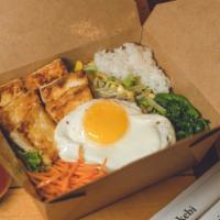 Fried Tofu Bibimbap · Traditional Korean rice bowl with lightly seasoned and sautéed vegetables and tofu, topped w...