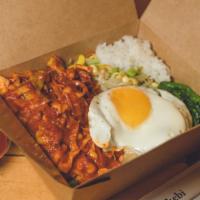 Spicy Seafood Bibimbap · Traditional Korean rice bowl with lightly seasoned and sautéed vegetables and spicy seafood ...