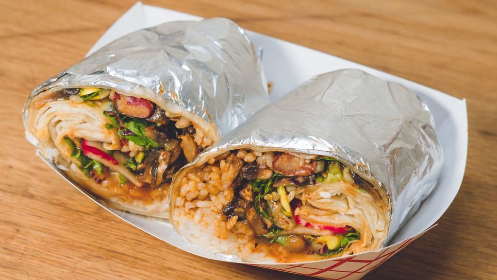 Vegan Spicy Mushroom Burrito · Sautéed homegrown oyster & button mushrooms sautéed with our spicy house-made Korean BBQ sauce,  wrapped in a flour tortilla with jasmine rice, three bean chili, bean sprouts, lettuce, soy dressing, and radish