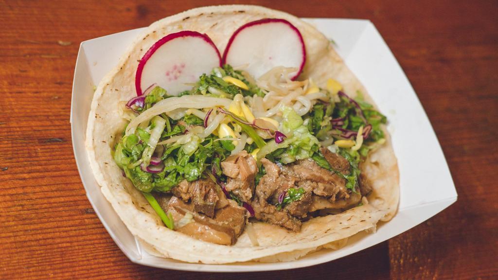 Pork Belly Taco · Soy braised Berkshire 
pork belly served on corn tortillas with bean sprouts, red leaf lettuce, soy dressing, and radish