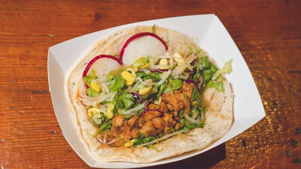 Spicy Pork Taco · Berkshire pork shoulder 
sautéed with our spicy house-made
Korean BBQ sauce  served on corn tortillas with bean sprouts, red leaf lettuce, soy dressing, and radish