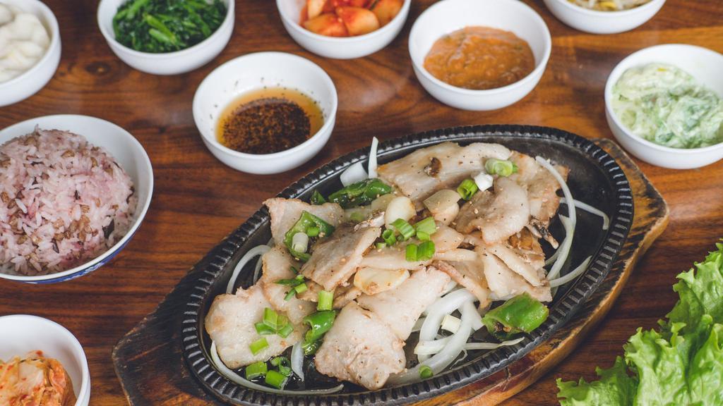Samgyeopsal · Sliced un-marinated pork belly sautéed with onions, garlic and Korean peppers. Served with fresh veggies, sesame oil with salt and pepper, and bean paste with your choice of white rice or mixed grain rice.