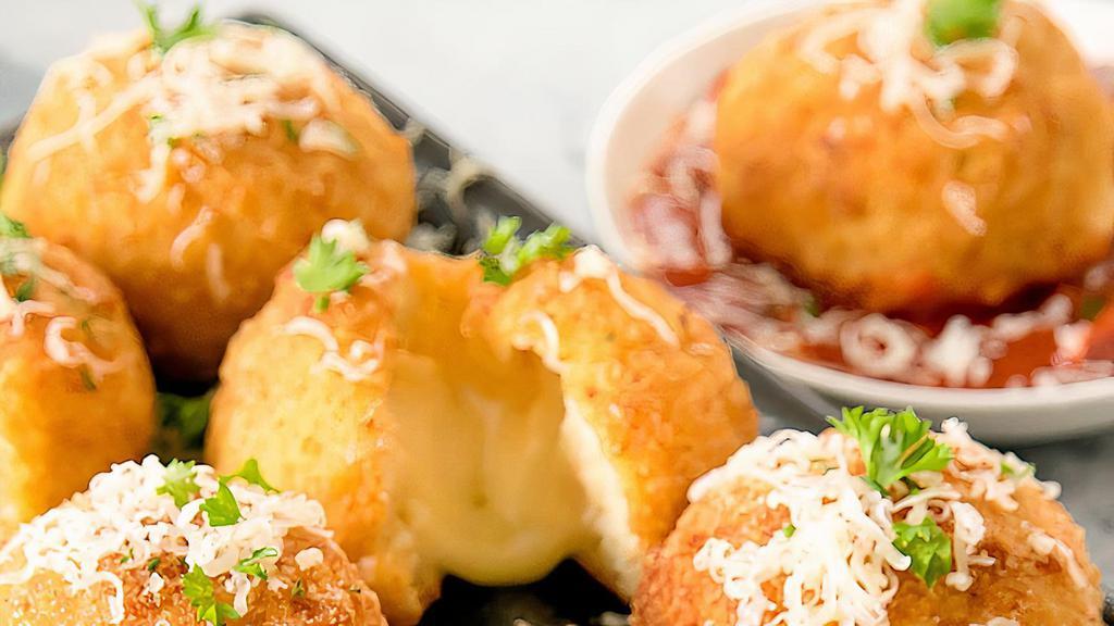 Arancini With Cheese · Arancini are Italian rice balls that are stuffed with mozzarella cheese,  coated with bread crumbs and deep fried, and are a staple of Sicilian cuisine. Served with our in house marinara sauce.
2 pieces with every order