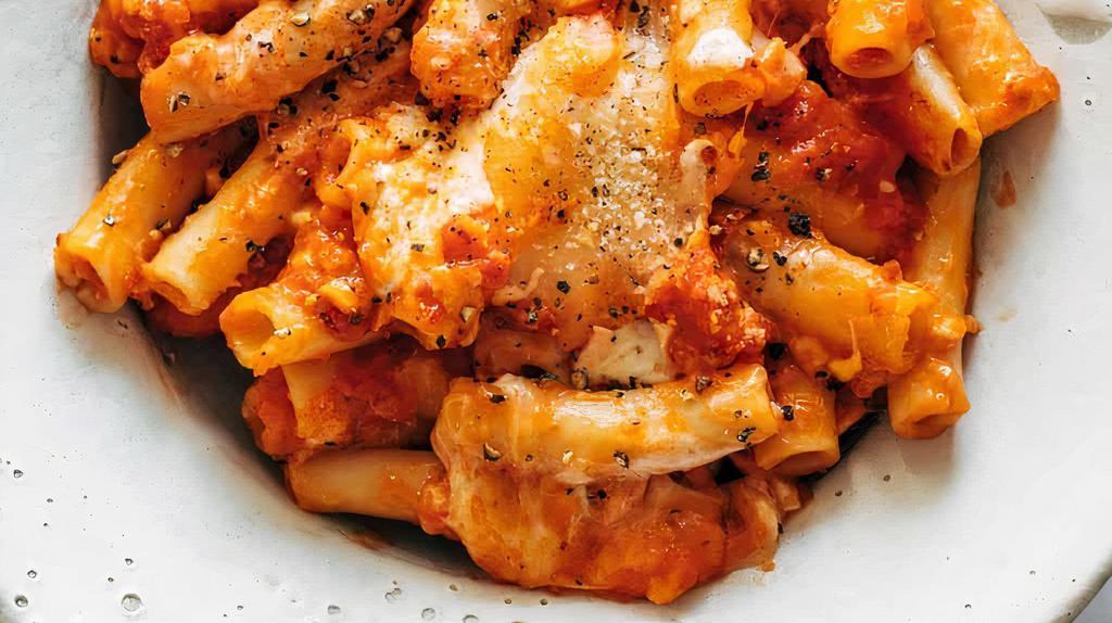 Baked Ziti With Roasted Chicken · Rigatoni pasta in our in house marinara sauce, with fresh ricotta, roasted chicken pieces, mozzarella and parmesan cheese topped with fresh basil and grated parmesan cheese then baked.