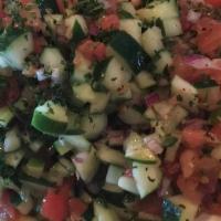Shirazi Salad · Gluten free. Crunchy diced cucumber, tomatoes, red onions and parsley in a light lemon dress...