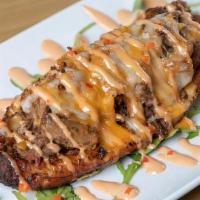 Maduro Ofelia · Sweet plantain stuffed with shredded beef, hogao and Monterrey jack cheese, topped in pink s...