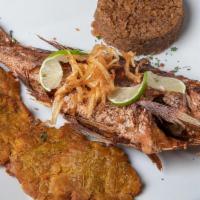 Pargo Rojo · Whole fried red snapper served with coconut rice and fried green plantain / Pescado entero s...