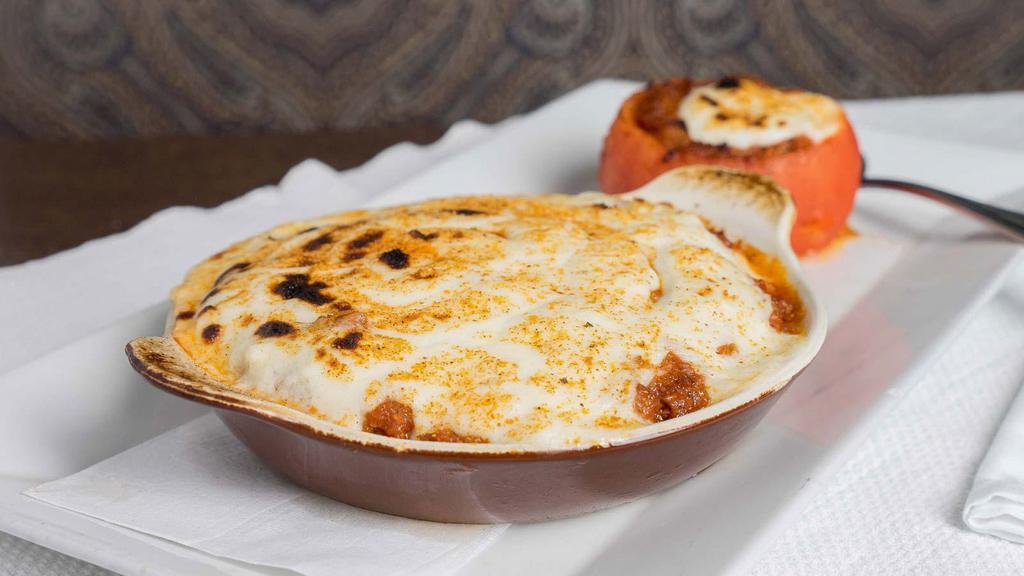 Baked Moussaka · Layers of Seasoned Ground Beef and Eggplant Baked with a Bechamel Cream Sauce.