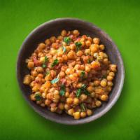 Spiced Chickpea Fiesta (Vegan) · Delicious chickpeas cooked in an exotic blend of  Indian spices and garnished with cilantro.