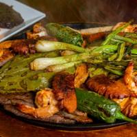 Parrillada Pancho Villa · Grilled steak , sausage , shrimp , cactus , onions , grilled chicken breast and peppers